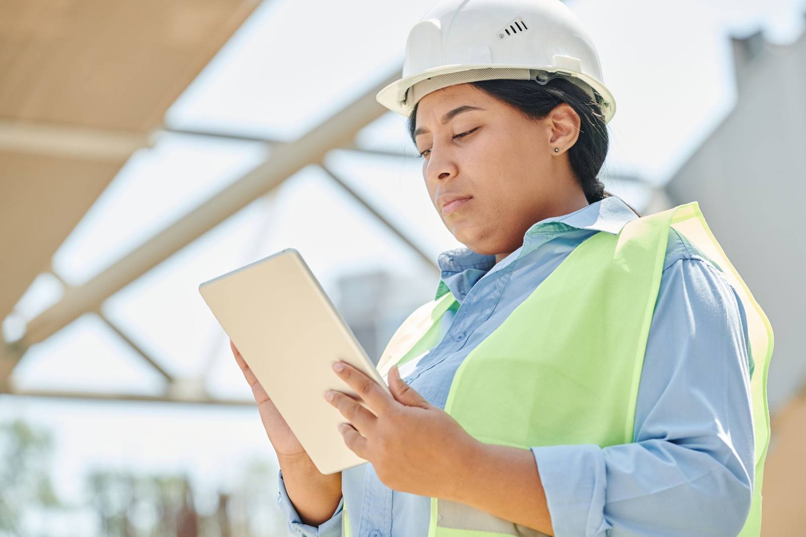 Surveyor recording measurements on a tablet